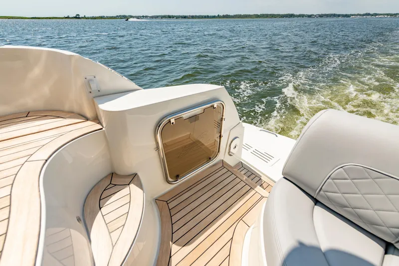  Yacht Photos Pics Luxurious 2017 Sea Ray Fly 510 yacht deck with elegant wood finish, cruising on open water.
