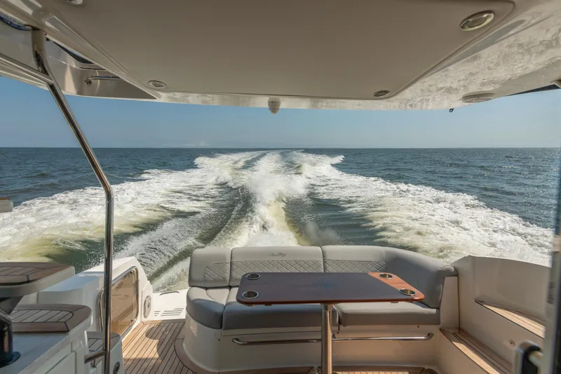  Yacht Photos Pics 2017 Sea Ray Fly 510 yacht cruising on open water, view from rear seating area.