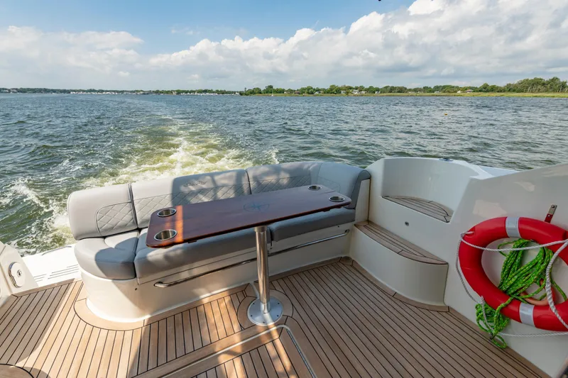  Yacht Photos Pics Luxurious 2017 Sea Ray Fly 510 yacht deck with seating and scenic water view.