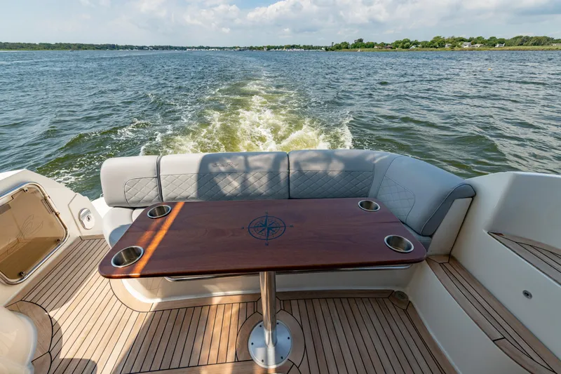  Yacht Photos Pics Luxurious 2017 Sea Ray Fly 510 yacht with elegant deck seating and wooden table on open water.