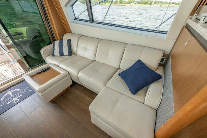 Yacht Photos Pics Luxurious interior of 2017 Sea Ray Fly 510 yacht with cream leather sofa and blue cushions.