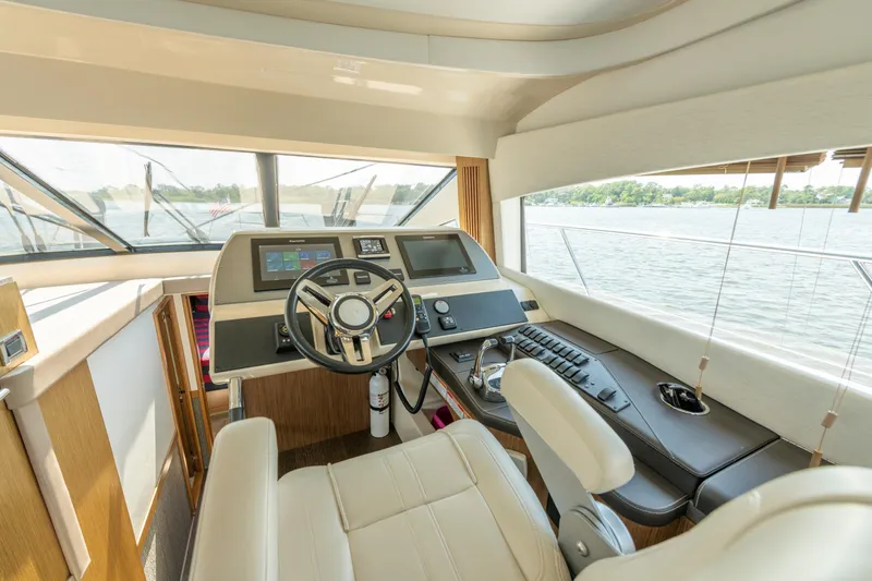  Yacht Photos Pics Luxurious helm of 2017 Sea Ray Fly 510 yacht with modern controls and panoramic view.