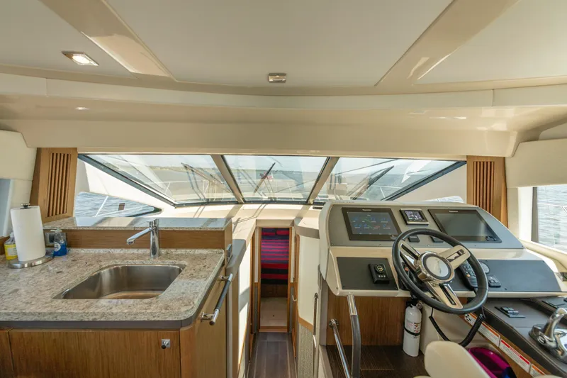 Yacht Photos Pics Interior of 2017 Sea Ray Fly 510 yacht with helm and kitchenette.