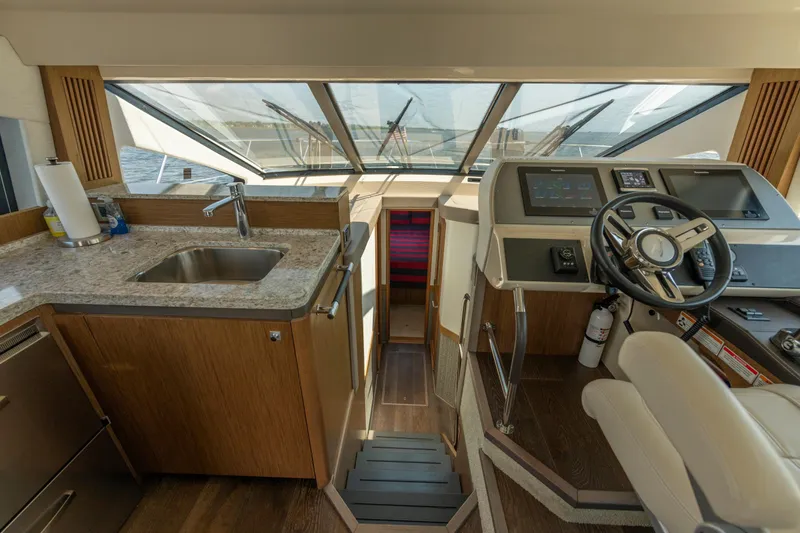  Yacht Photos Pics Luxurious 2017 Sea Ray Fly 510 yacht interior with helm, sink, and modern controls.