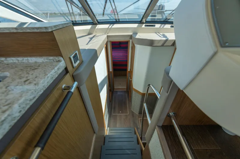  Yacht Photos Pics Interior view of 2017 Sea Ray Fly 510 yacht, featuring modern design and wooden finishes.
