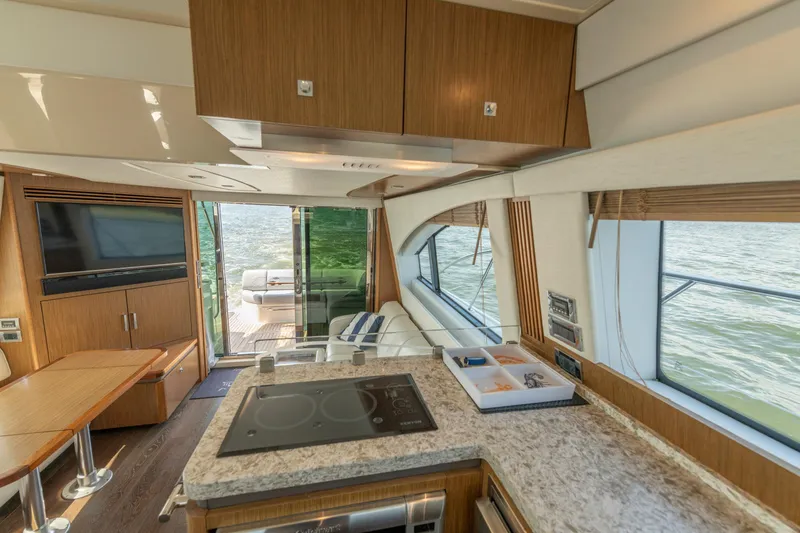  Yacht Photos Pics Luxurious interior of 2017 Sea Ray Fly 510 yacht with modern kitchen and scenic water view.