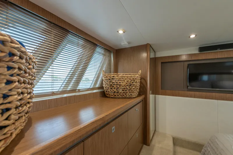  Yacht Photos Pics Luxurious interior of 2017 Sea Ray Fly 510 yacht with wooden cabinetry and woven basket.