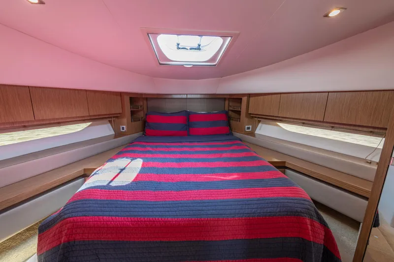  Yacht Photos Pics Luxurious 2017 Sea Ray Fly 510 yacht bedroom with striped bedding and natural light.