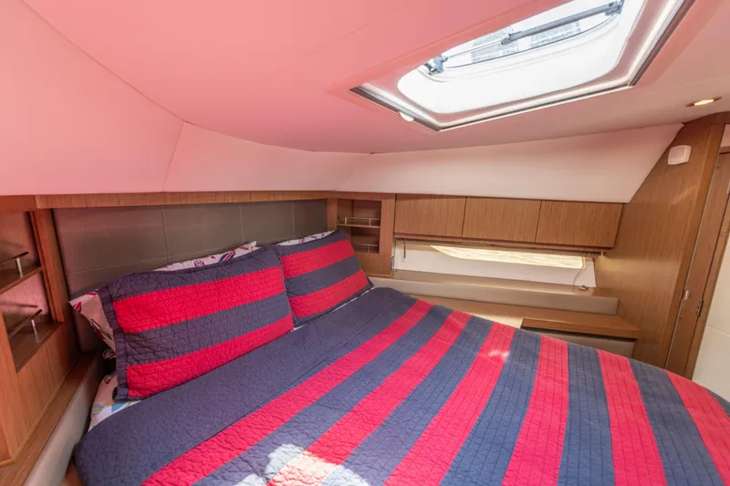  Yacht Photos Pics Luxurious cabin interior of 2017 Sea Ray Fly 510 yacht with striped bedding.