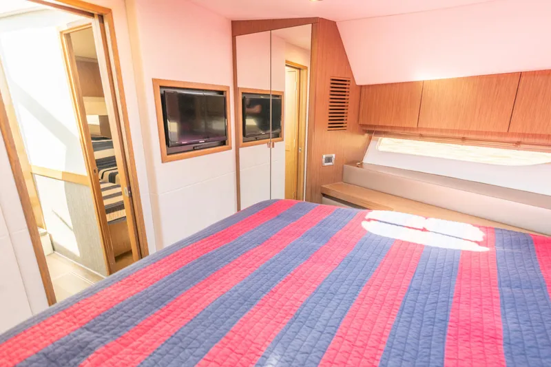  Yacht Photos Pics Luxurious 2017 Sea Ray Fly 510 yacht bedroom with striped bedding and modern decor.