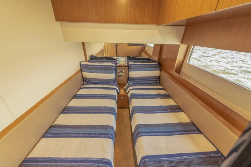  Yacht Photos Pics 2017 Sea Ray Fly 510 cabin with twin beds and striped bedding.