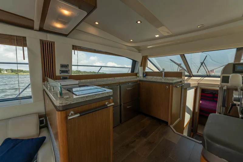  Yacht Photos Pics Luxurious interior of 2017 Sea Ray Fly 510 yacht with modern kitchen and scenic windows.