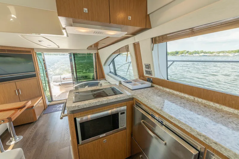  Yacht Photos Pics Luxurious interior of 2017 Sea Ray Fly 510 yacht with modern kitchen and scenic water view.