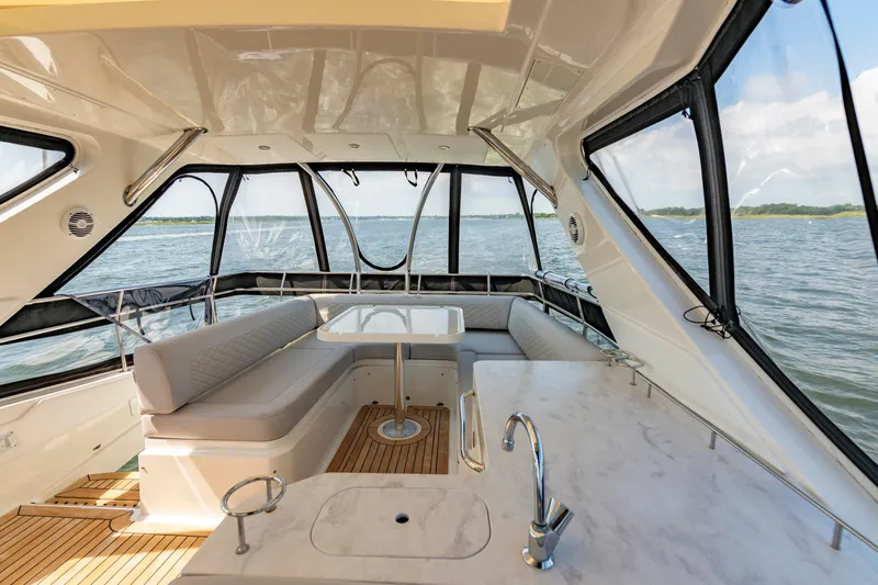  Yacht Photos Pics Luxurious interior of 2017 Sea Ray Fly 510 yacht with panoramic windows and elegant seating.