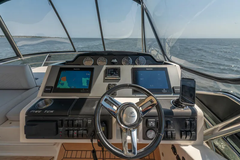  Yacht Photos Pics 2017 Sea Ray Fly 510 yacht helm with navigation screens and steering wheel.