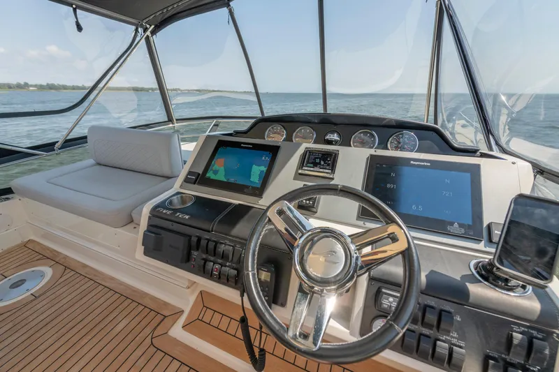  Yacht Photos Pics 2017 Sea Ray Fly 510 yacht helm with navigation screens and steering wheel.