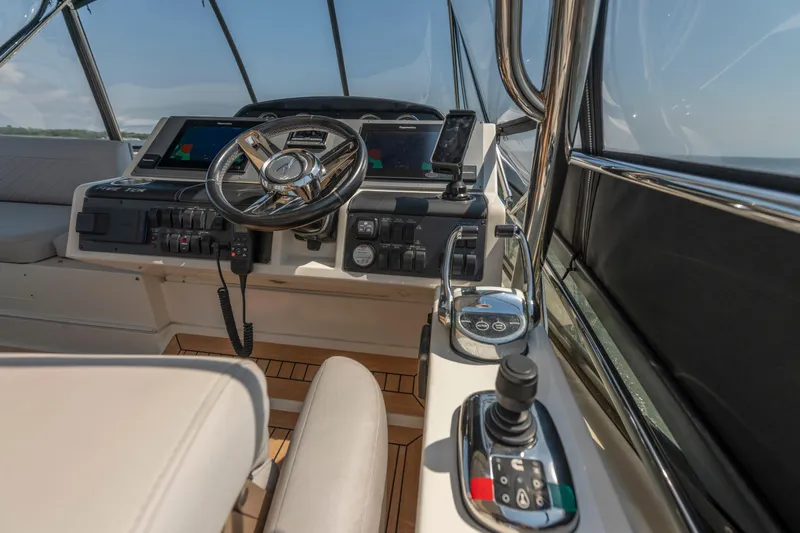  Yacht Photos Pics 2017 Sea Ray Fly 510 yacht cockpit with modern controls and steering wheel.