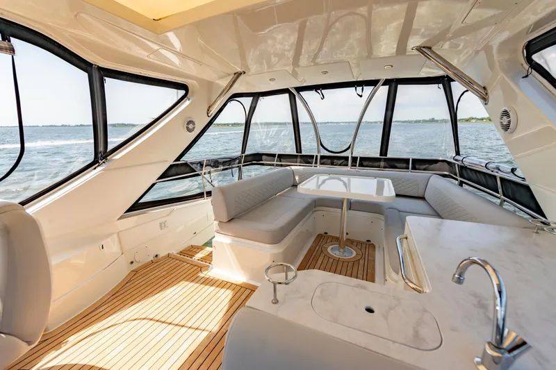  Yacht Photos Pics Luxurious interior of 2017 Sea Ray Fly 510 yacht with panoramic windows and elegant seating.