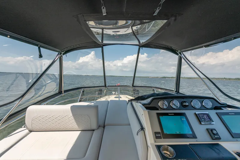  Yacht Photos Pics Cockpit view of 2017 Sea Ray Fly 510 yacht with navigation screens and ocean backdrop.
