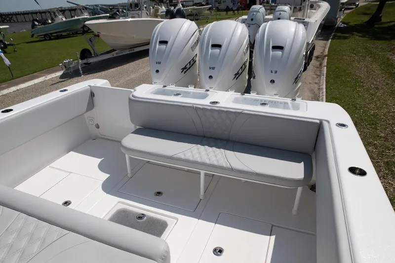  Yacht Photos Pics 2024 Contender 39 ST boat with triple outboard engines and spacious seating area.