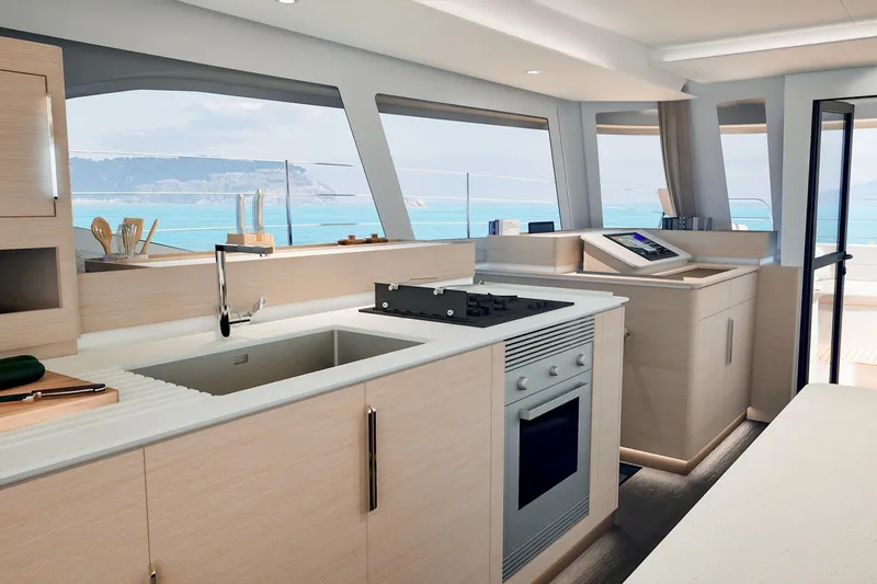  Yacht Photos Pics Modern kitchen interior of 2026 Fountaine Pajot FP 55 yacht with ocean view.