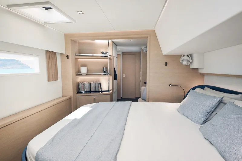  Yacht Photos Pics Luxurious bedroom interior of 2026 Fountaine Pajot FP 55 yacht, featuring modern design and cozy ambiance.