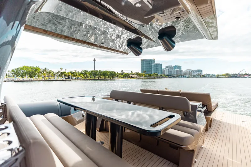  Yacht Photos Pics Luxurious Anvera 48 yacht interior with sleek seating and table, overlooking scenic waterfront.