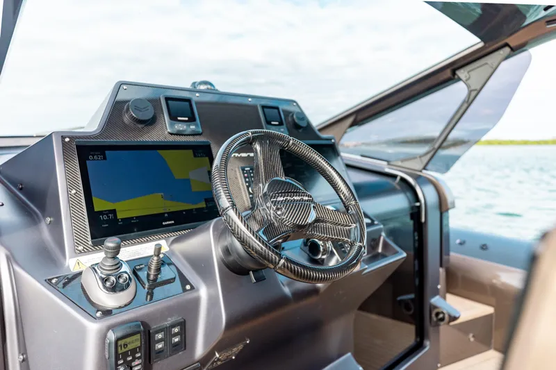  Yacht Photos Pics Steering console of 2025 Anvera 48 USA boat with navigation display and controls.