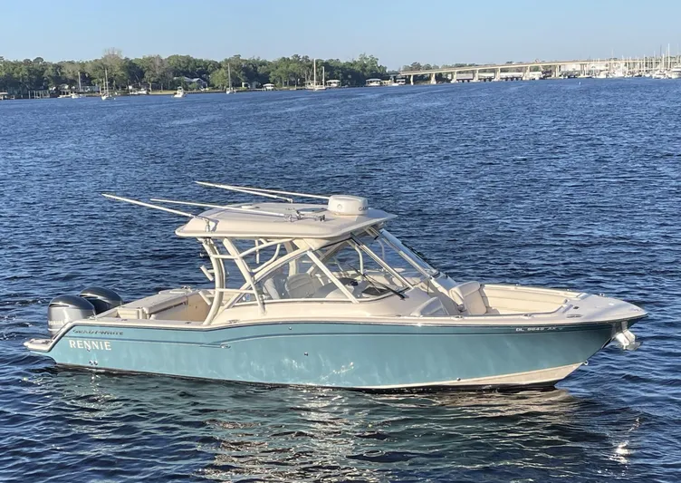 Rennie Yacht Photos Pics 2019 Grady-White Freedom 325 boat on calm water, clear sky background.