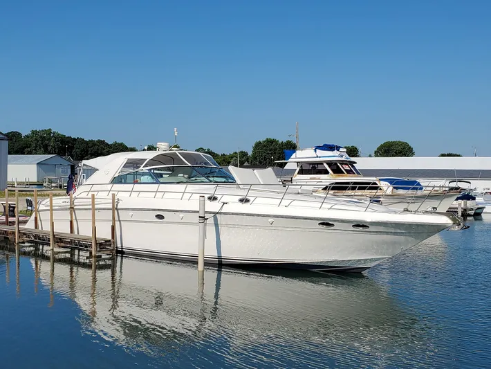  Yacht Photos Pics 1997 Sea Ray 580 Super Sun Sport yacht docked in a marina.