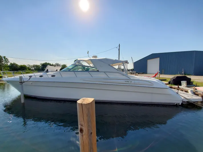  Yacht Photos Pics 1997 Sea Ray 580 Super Sun Sport yacht docked under clear sky.