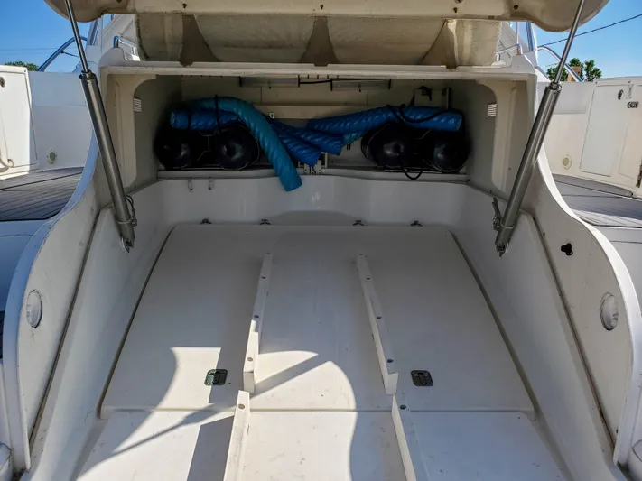  Yacht Photos Pics 1997 Sea Ray 580 Super Sun Sport boat storage compartment with blue hoses and equipment.