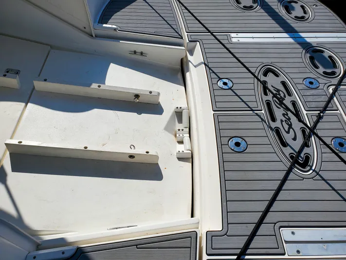  Yacht Photos Pics 1997 Sea Ray 580 Super Sun Sport deck with custom flooring and logo detailing.