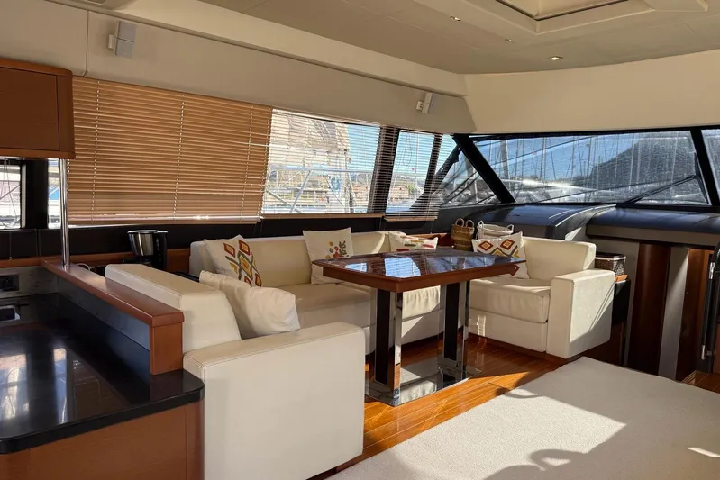  Yacht Photos Pics Luxurious interior of a 2011 Prestige 60 yacht with elegant seating and wooden accents.