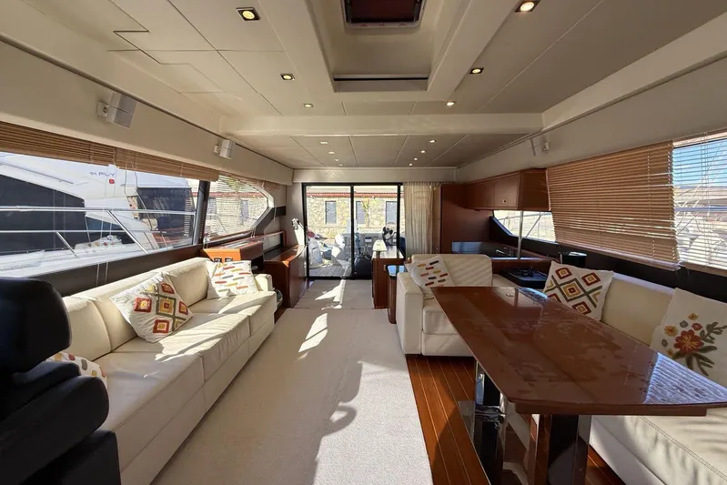  Yacht Photos Pics Luxurious interior of a 2011 Prestige 60 yacht with elegant seating and wooden accents.