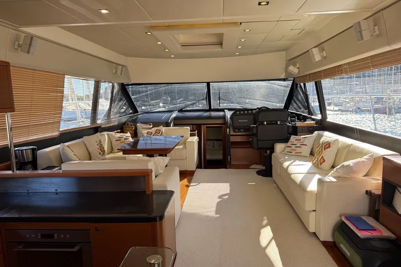  Yacht Photos Pics Luxurious interior of a 2011 Prestige 60 yacht with elegant seating and panoramic windows.