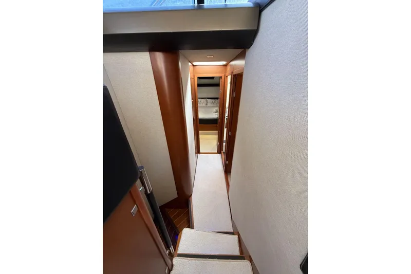  Yacht Photos Pics Interior hallway of 2011 Prestige 60 yacht, featuring wooden finishes and modern design.