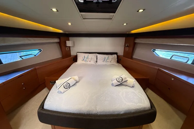  Yacht Photos Pics Luxurious bedroom interior of 2011 Prestige 60 yacht with elegant bedding and ambient lighting.