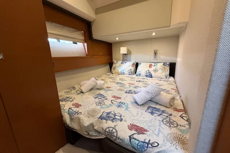  Yacht Photos Pics Luxurious cabin interior of 2011 Prestige 60 yacht with nautical-themed bedding.