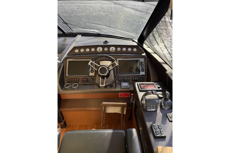  Yacht Photos Pics Cockpit of 2011 Prestige 60 yacht with steering wheel and navigation controls.