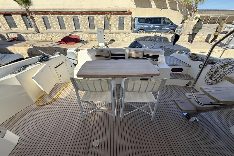  Yacht Photos Pics Deck of 2011 Prestige 60 yacht with seating and table, docked at marina.