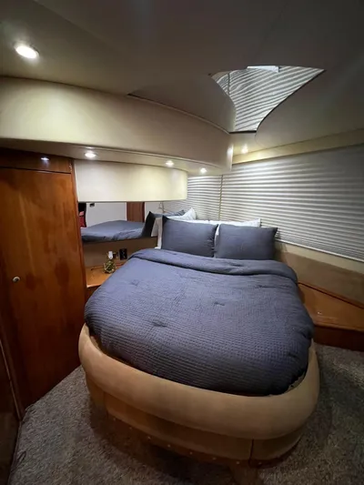  Yacht Photos Pics Luxurious bedroom interior of a 2001 Azimut 58 yacht with cozy bedding.