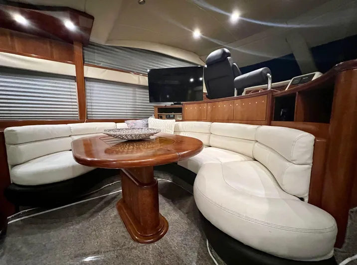  Yacht Photos Pics Luxurious interior of a 2001 Azimut 58 yacht with white leather seating and wooden table.