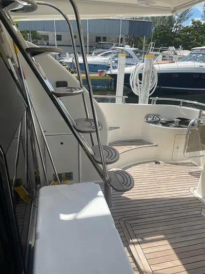  Yacht Photos Pics 2001 Azimut 58 yacht with teak deck and spiral staircase in marina.