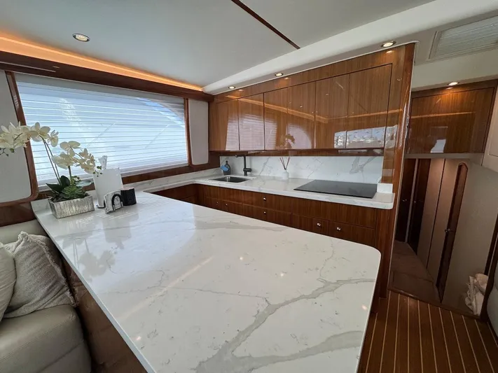 Yacht Photos Pics Luxurious kitchen interior of a 2007 Viking 52 Convertibles yacht with marble countertops.