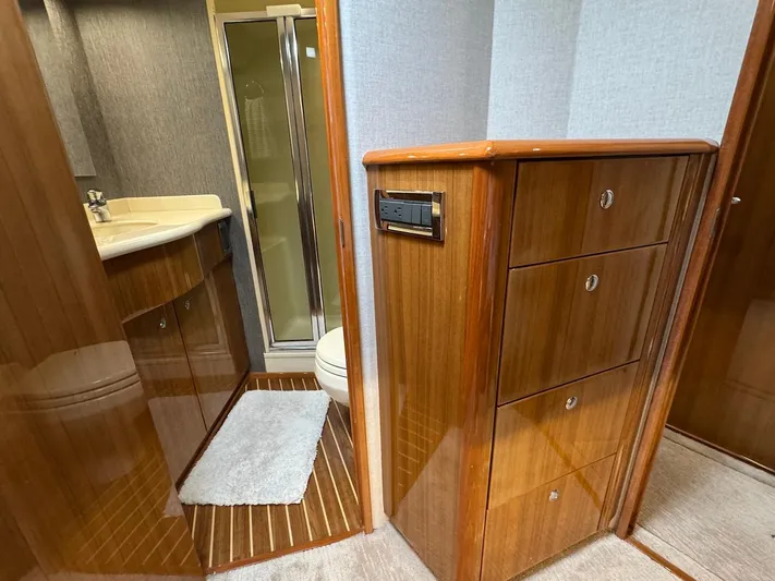  Yacht Photos Pics Luxurious bathroom interior of 2007 Viking 52 Convertibles yacht with wooden cabinetry.