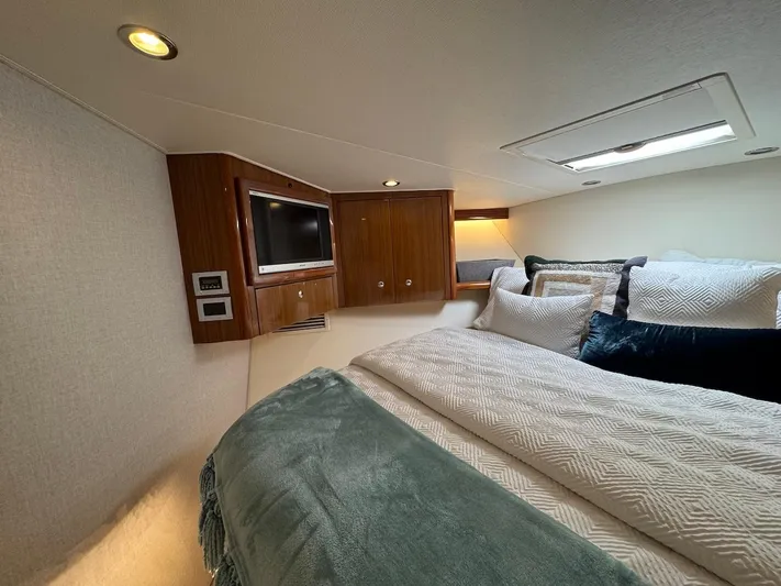  Yacht Photos Pics Luxurious bedroom interior of 2007 Viking 52 Convertibles yacht with cozy bedding and TV.