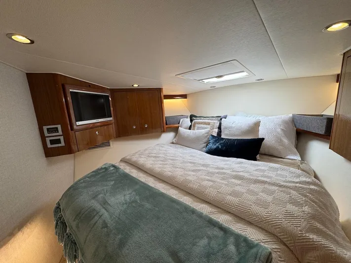  Yacht Photos Pics Luxurious bedroom interior of 2007 Viking 52 Convertibles yacht with cozy bedding and TV.