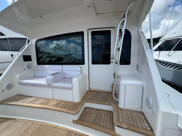  Yacht Photos Pics 2007 Viking 52 Convertibles yacht with teak deck and white seating area.