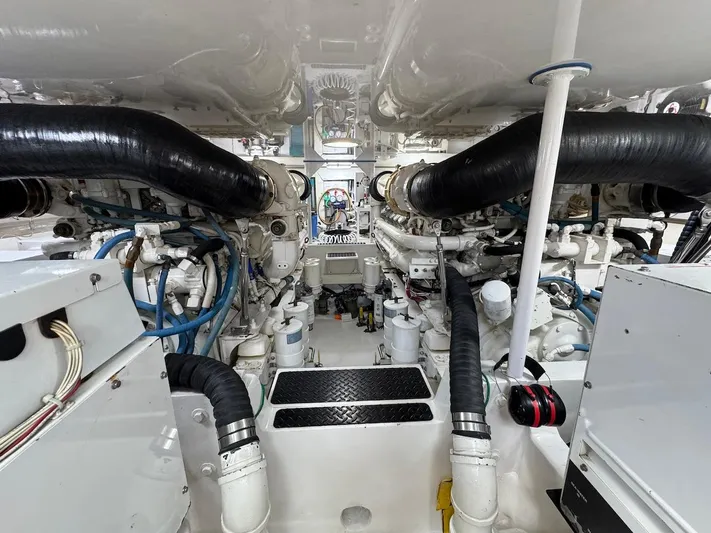  Yacht Photos Pics Engine room of a 2007 Viking 52 Convertibles yacht, showcasing complex machinery and piping.